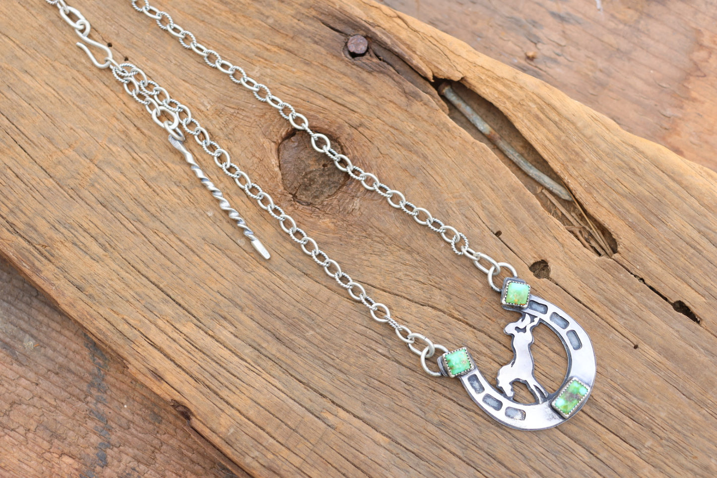 Horse shoe necklace with bucking bronco