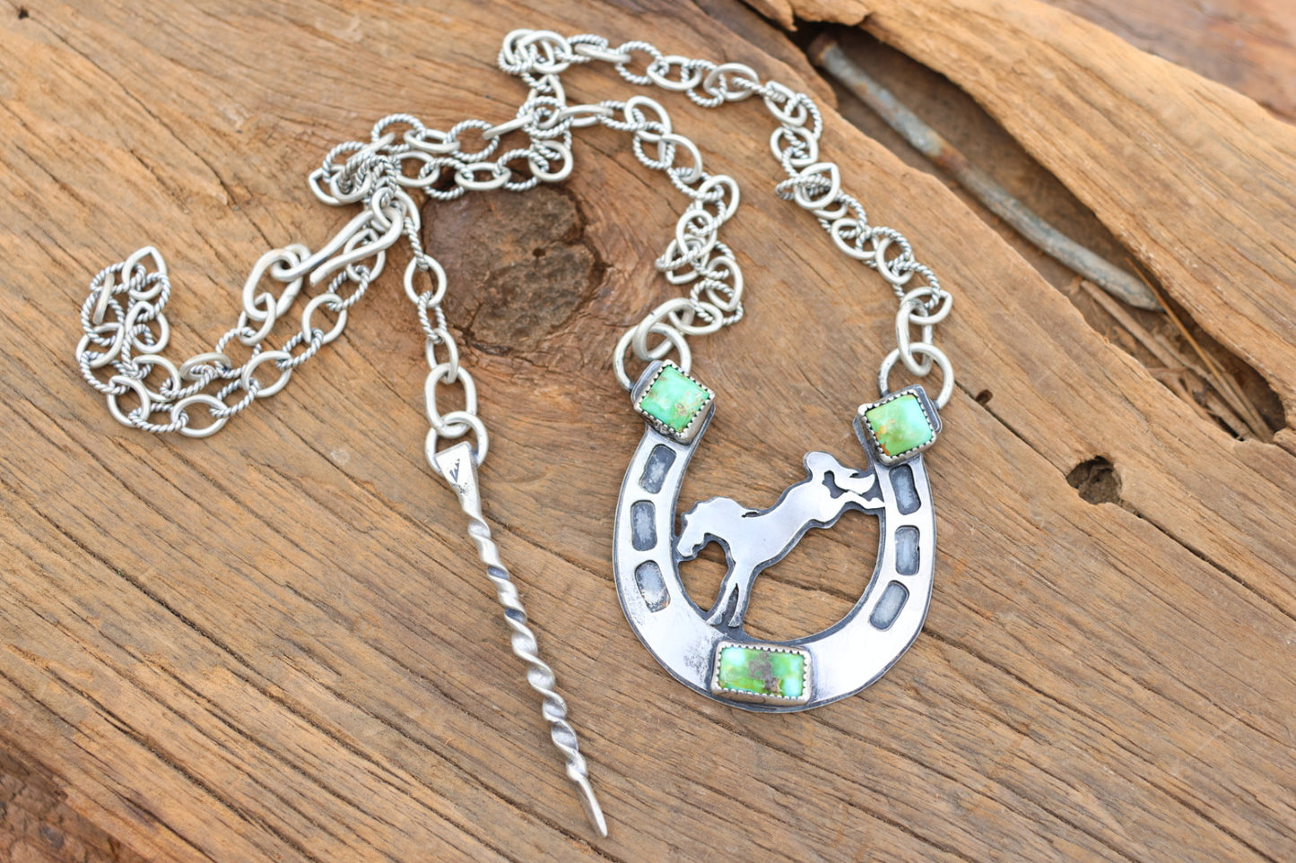 Horse shoe necklace with bucking bronco