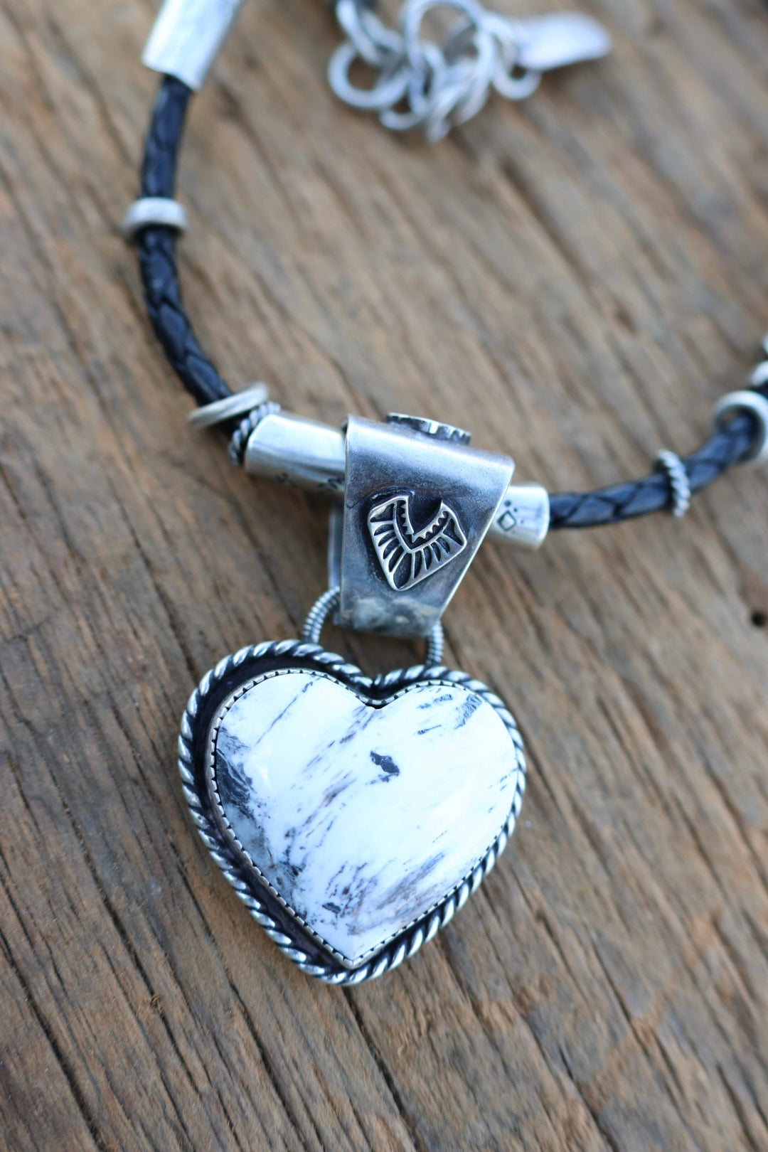 White buffalo Heart pendant on braided leather cord