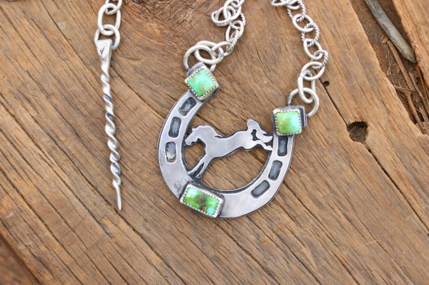 Horse shoe necklace with bucking bronco